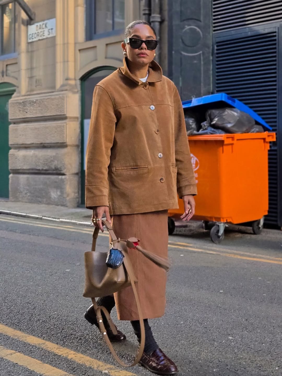 Woman wearing burgundy shoe outfit 2025.