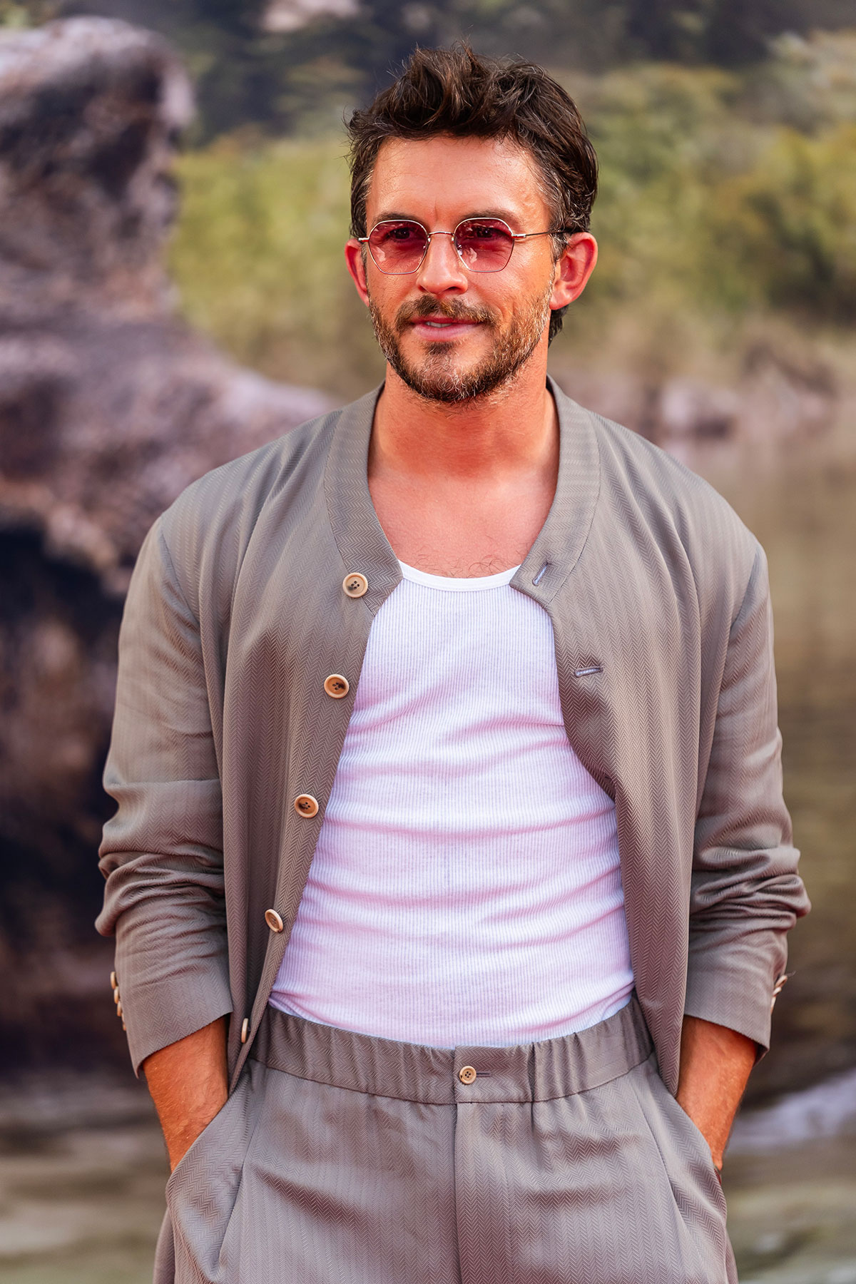 Jonathan Bailey wearing wire-frame sunglasses.