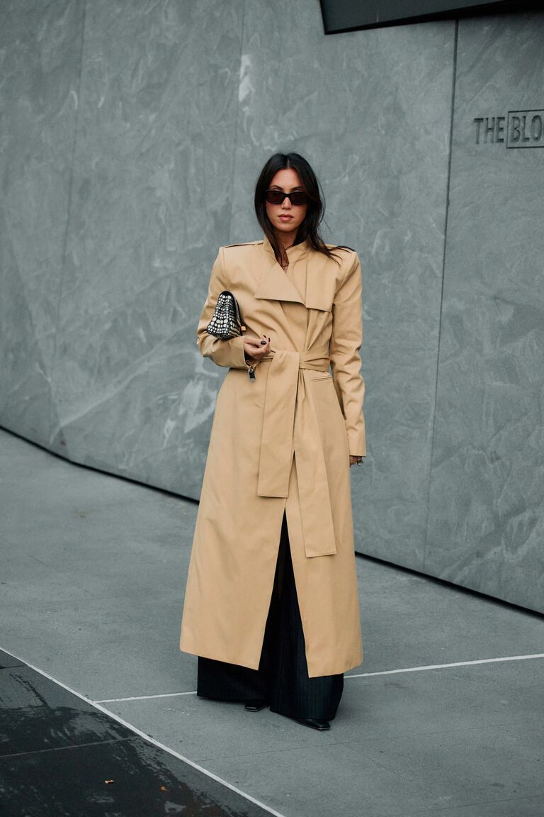Woman wearing tan outerwear during NYFW S/S 26.