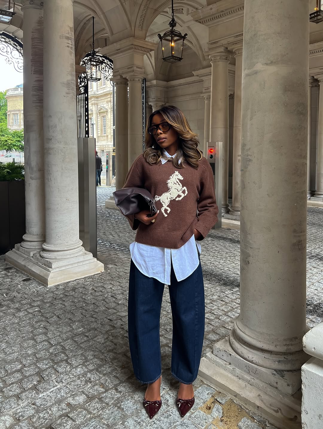 Woman wearing burgundy shoe outfit 2025.