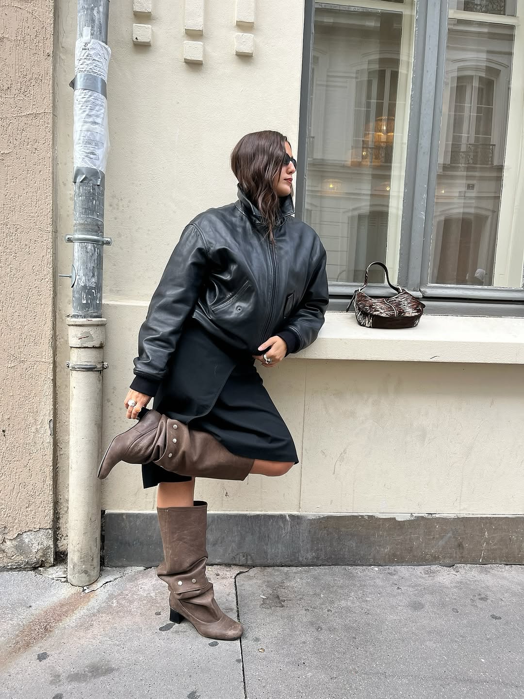 Woman wearing a 2025 slouchy boot outfit.