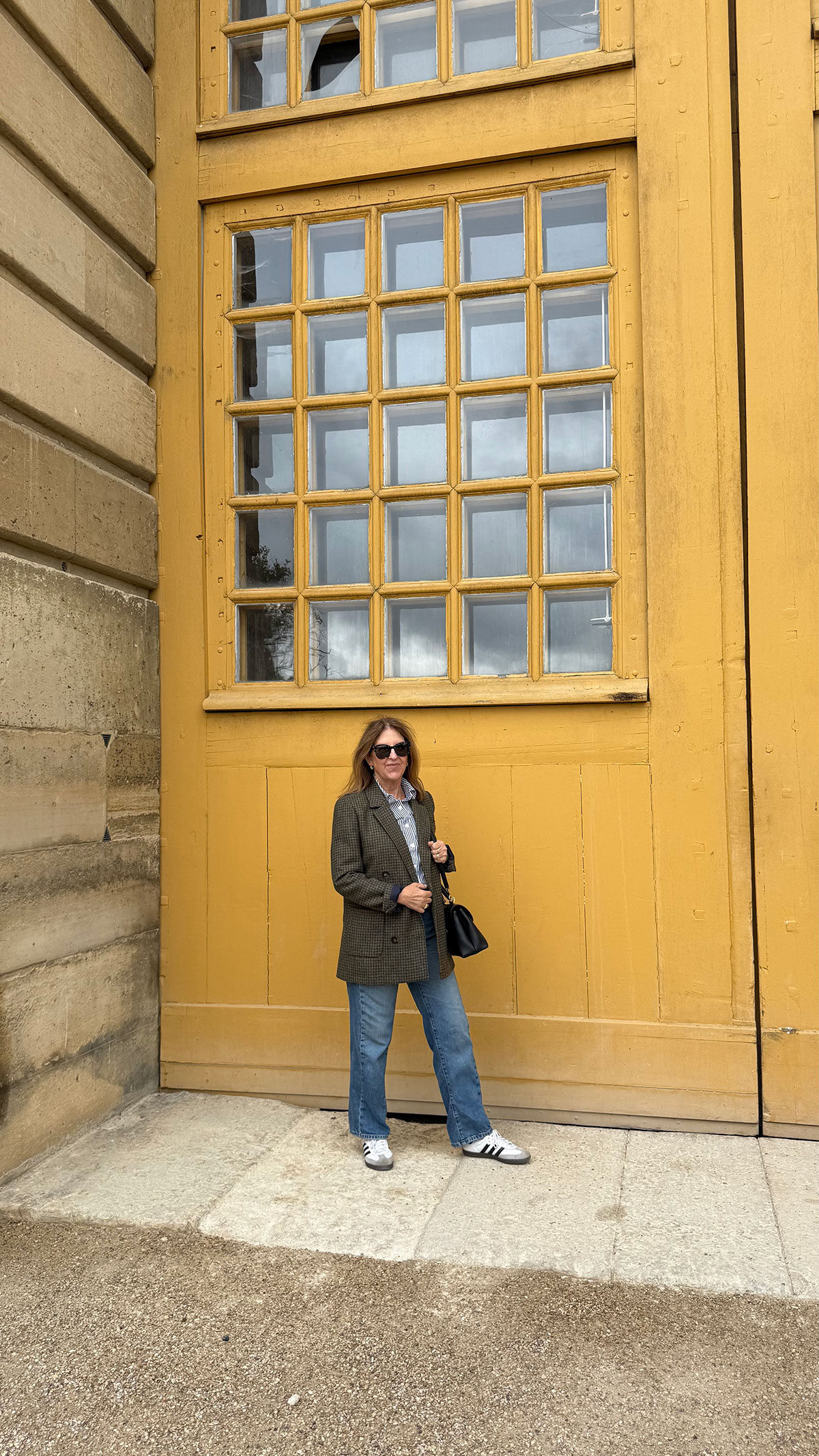 A Nordstrom stylist wearing a structured handbag in Paris.