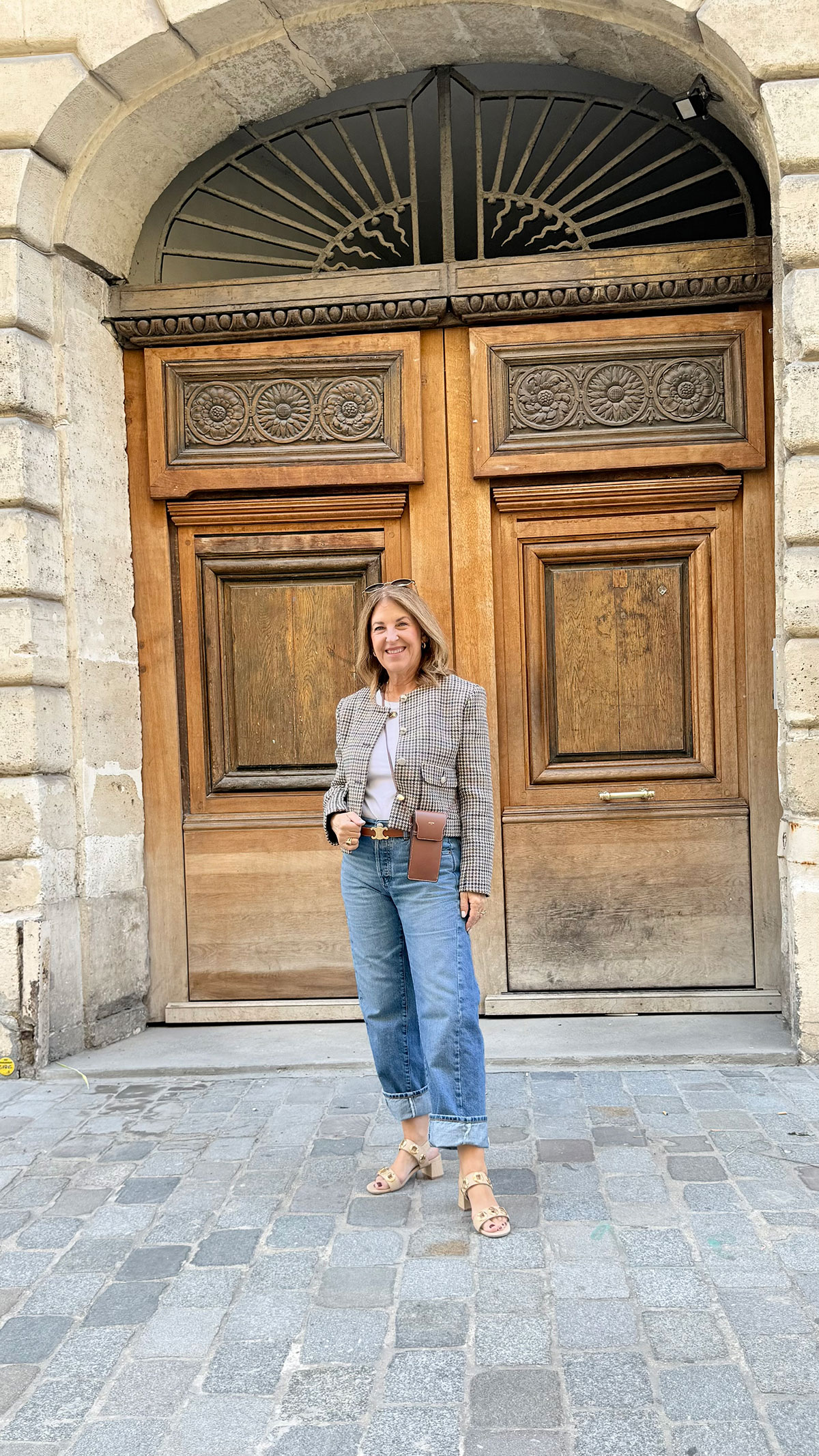 A Nordstrom stylist wearing a cropped houndstooth jacket in Paris.