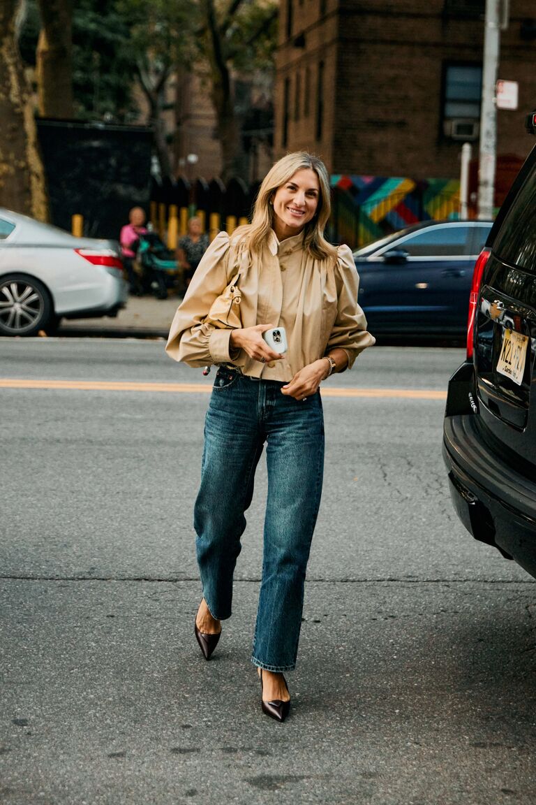 Woman wearing tan outerwear during NYFW S/S 26.