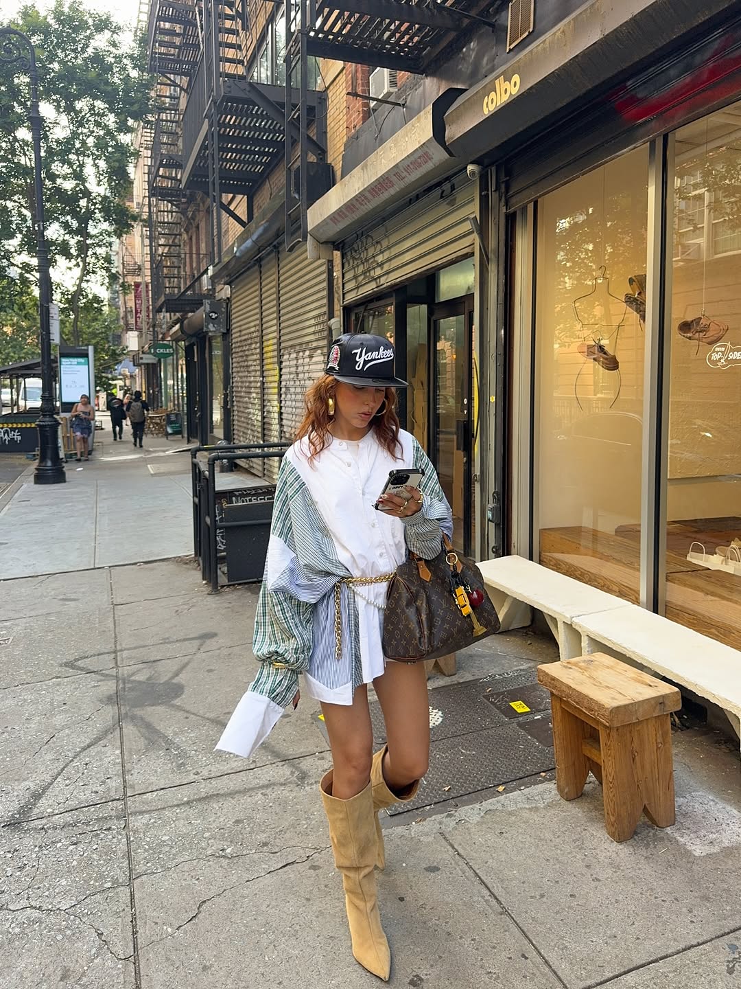 Woman wearing a 2025 slouchy boot outfit.