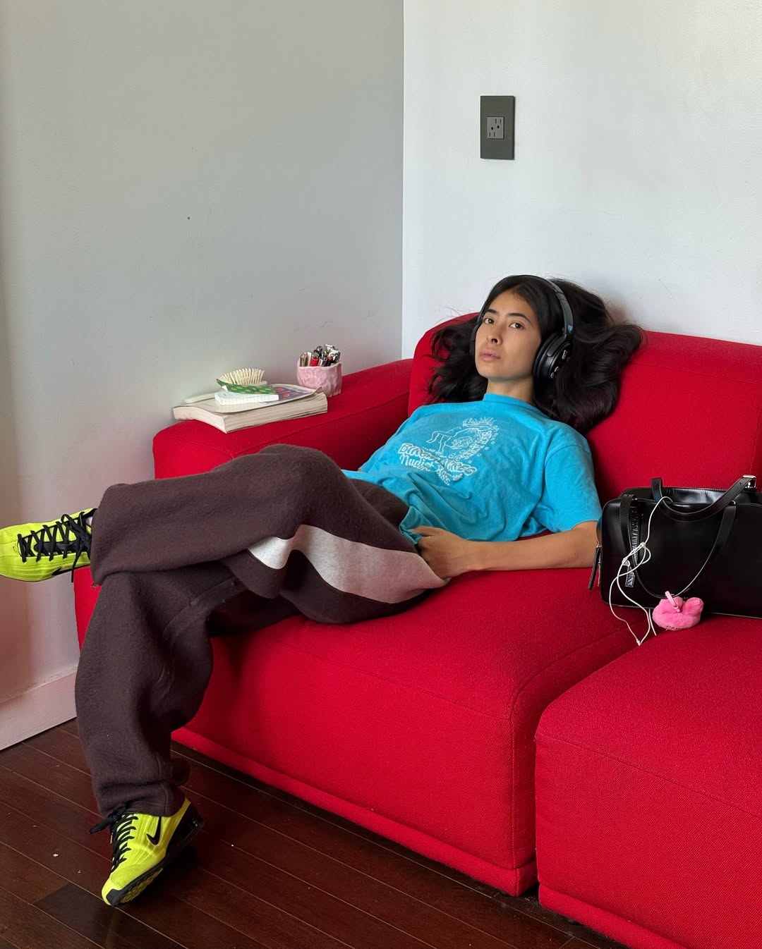 Michelle Li wearing Tory Burch track pants and green Nike sneakers