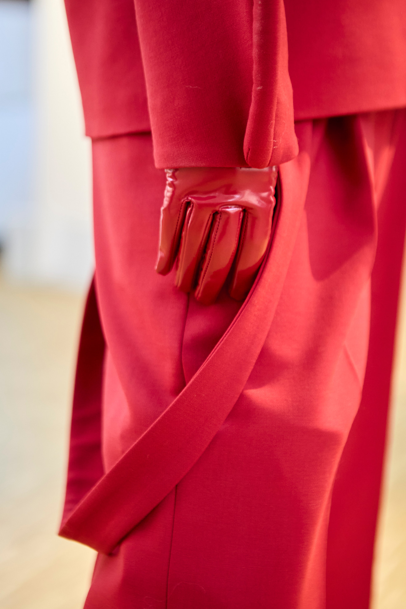 Model wearing colored gloves on the runway.