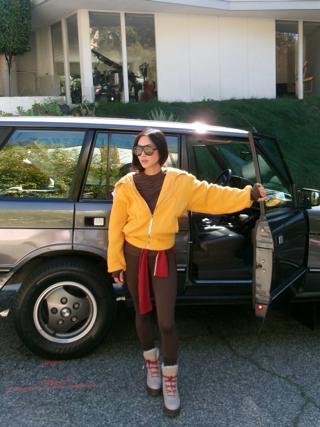 Aimee Song in a fleece jacket and leggings.