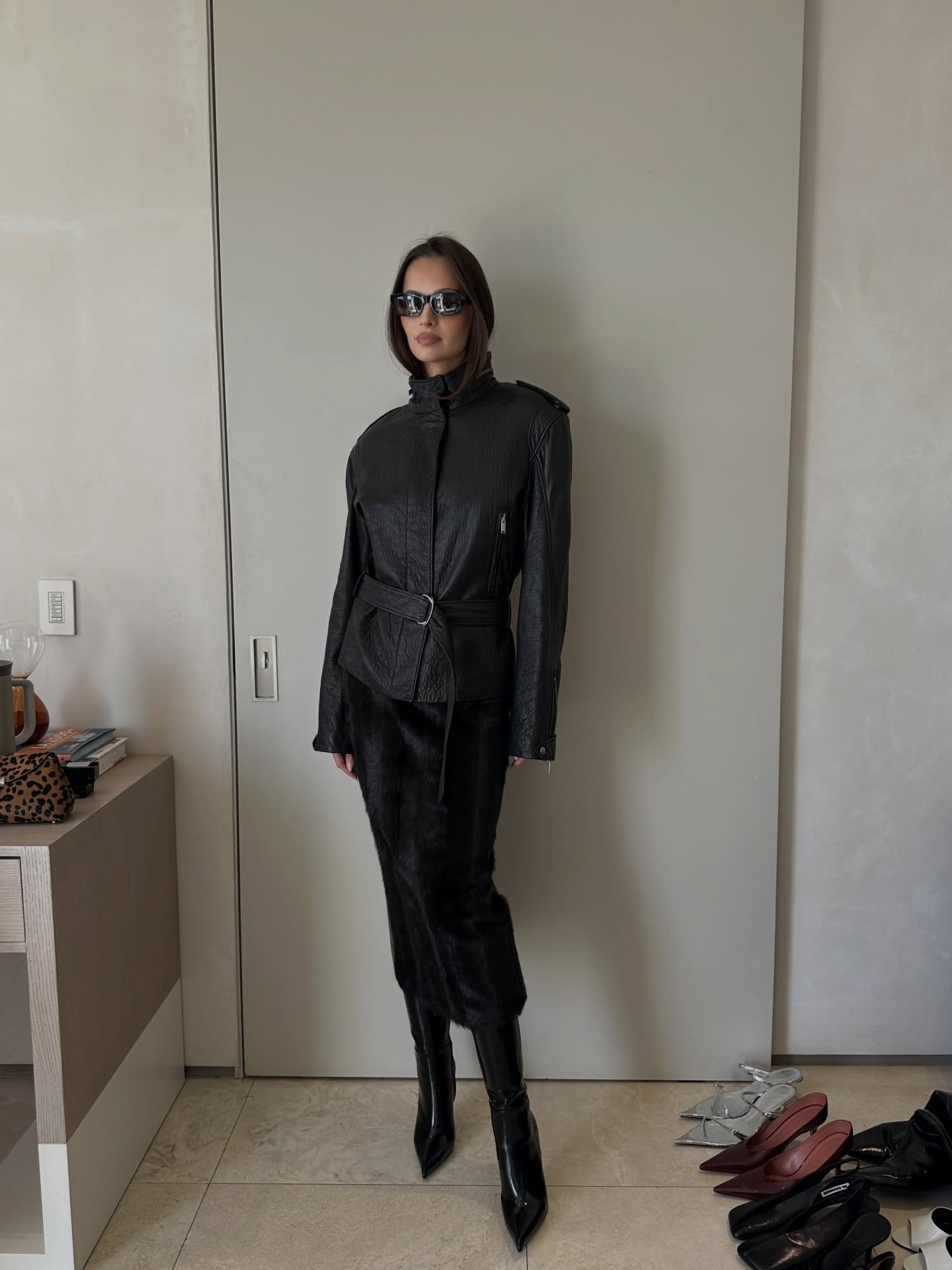 Pia Mance wearing a skirt outfit idea for 2026, including a leather jacket and black pony hair pencil skirt.