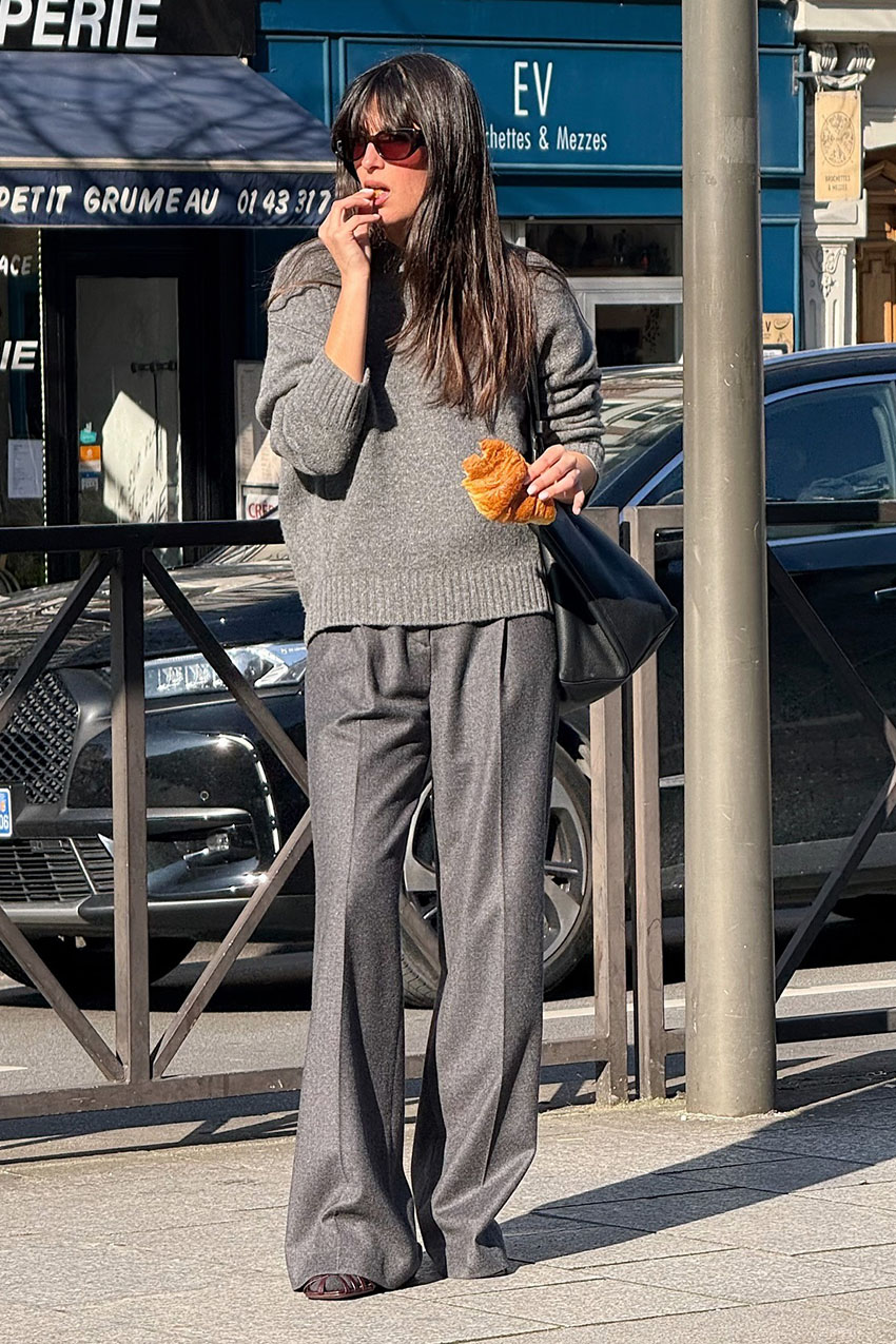 A woman wearing a gray cashmere sweater and gray pants