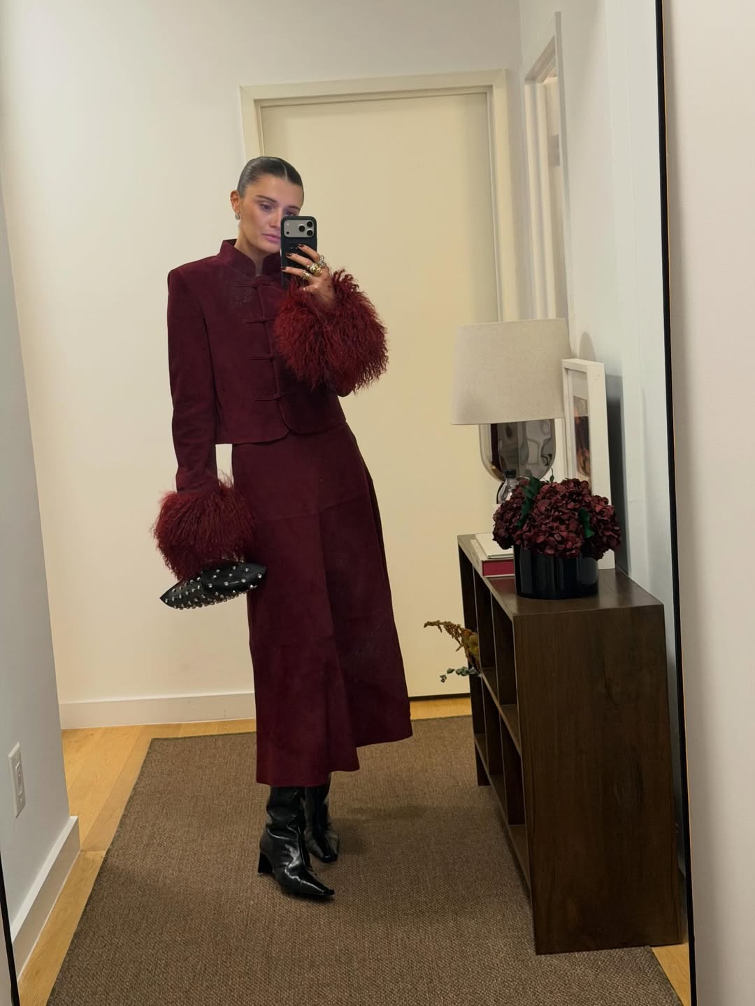 Coco Schiffer wearing a red skirt and cropped jacket set