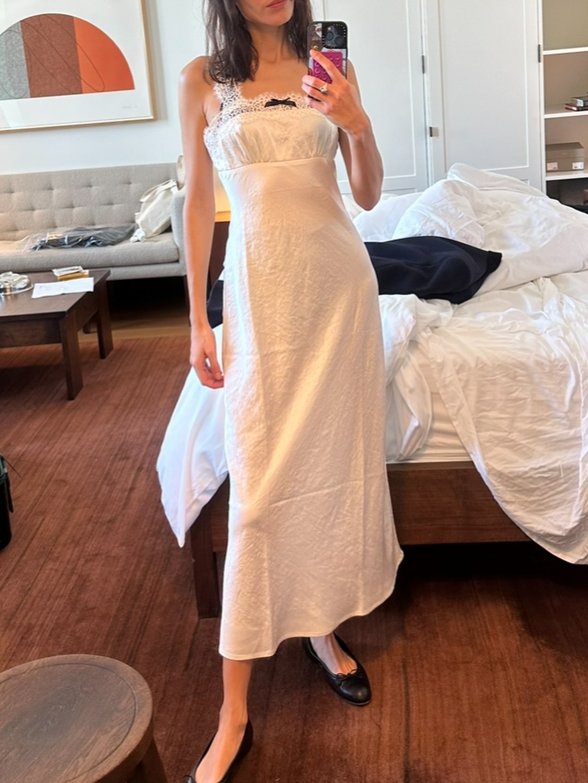 Alexa Chung wearing a white lace slip dress with ballet flats.